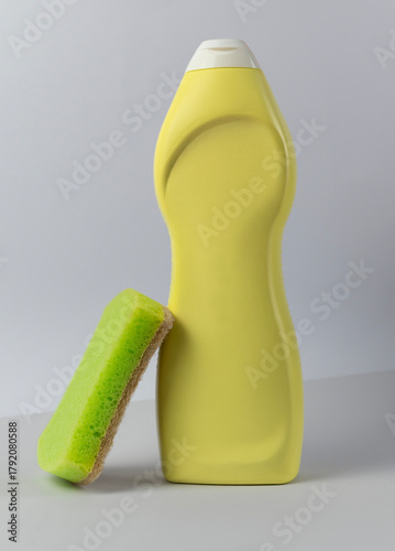 Plastic bottle for detergent with sponge on white background mockup