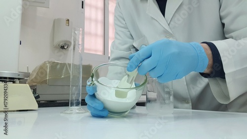 Pharmacist compounding ointment with mortar and pestle