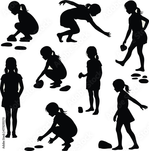 Silhouettes of Young Girls Engaged in Play with Stones children