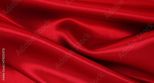 Smooth elegant red silk or satin luxury cloth texture as abstract background. Luxurious valentines day background design