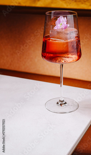 Elegant drink with flower garnish on table at stylish venue