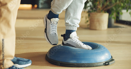 Foto Feet, person and balance on ball for physiotherapy at house with assistance for mobility training