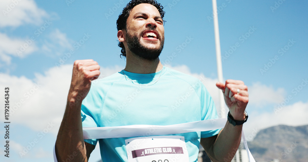 Naklejka premium Man, marathon and celebration with ribbon at finish line with low angle, goals and winning performance. Person, champion and happy runner with achievement, success and fist pump for sports milestone