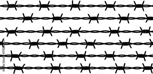 Barbed wire strands, sharp metal barbs, security fencing, protective barrier, twisted wire, danger zone, boundary control, deterrent, safety, enclosure