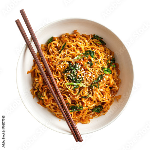 Noodles with greens, sesame, and chopsticks, in a white bowl, top view