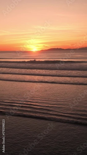 Aerial view of beautiful Indian Ocean at sunset time.Slow motion.Vertical video