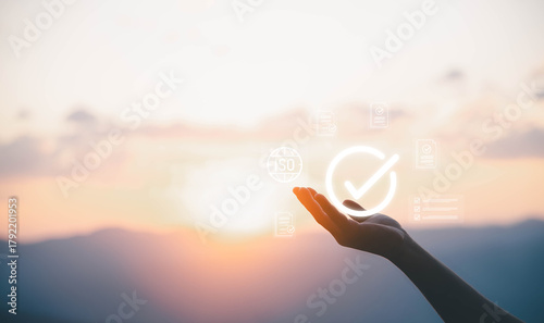 Foto Businessman holding digital ISO icon with certification documents, symbolizing international standards, quality control assurance, compliance, regulation, auditing, and global business certification