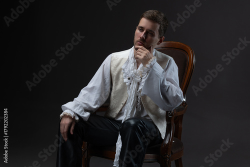 A young man in an early Baroque outfit, a white blouse with lace and ruffles, a white vest, a classic vintage suit, an unbuttoned vest, an image with a touch of decadence, a theatrical hero, a photo