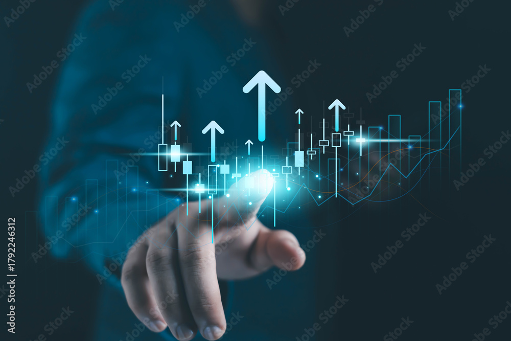 Fototapeta premium Business hand touching digital financial growth chart with rising arrows, candlestick data, and futuristic analytics interface representing market trends, investment strategy, and economic success.