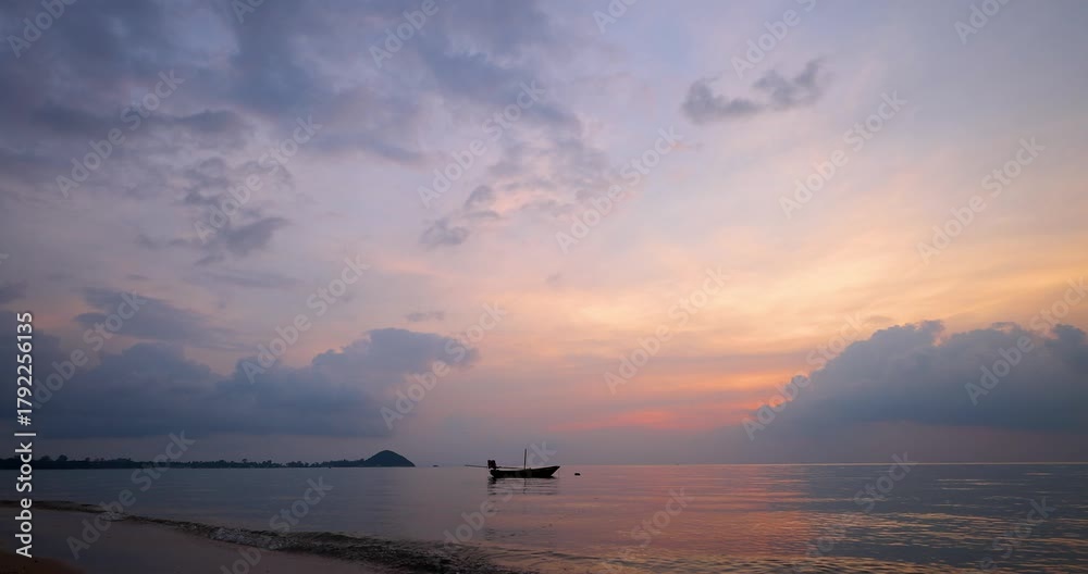 Peaceful tropical seascape with a small fishing boat floating on calm water at sunset. The sky glows in soft pastel hues of pink, orange, and blue, reflecting beautifully on the tranquil sea surface.