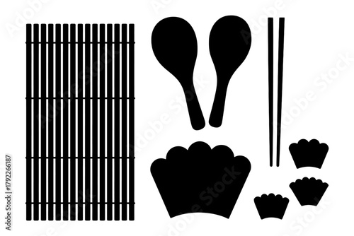 Sushi mat and utensil set with rolling bamboo mat, spoons, chopsticks, and shrimp tail dishes.