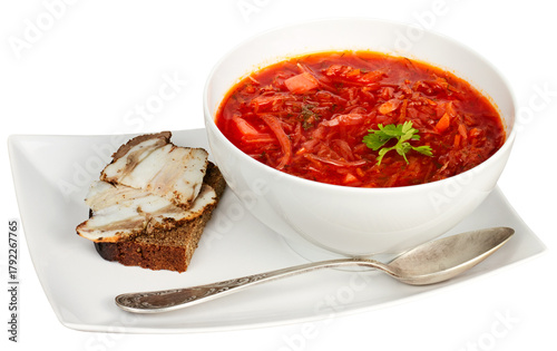 Borscht served with bread and lard isolated on white with clipping path.