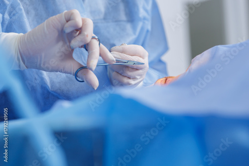 Tableau sur toile Blepharoplasty eyelid suturing with needle holder in a sterile ophthalmic operat