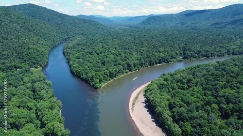 View from above. The confluence of two rivers with clean and dirty water. River pollution. Gold mining. An environmental disaster.