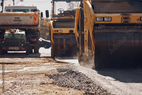 Fototapete Public city street reconstruction with heavy machines.