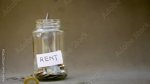 Slow Motion of Coins Dropping into Saving Jar Labeled 