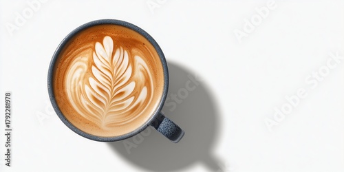 Top-down image of a ceramic coffee mug with latte art, clean shadow on white background.