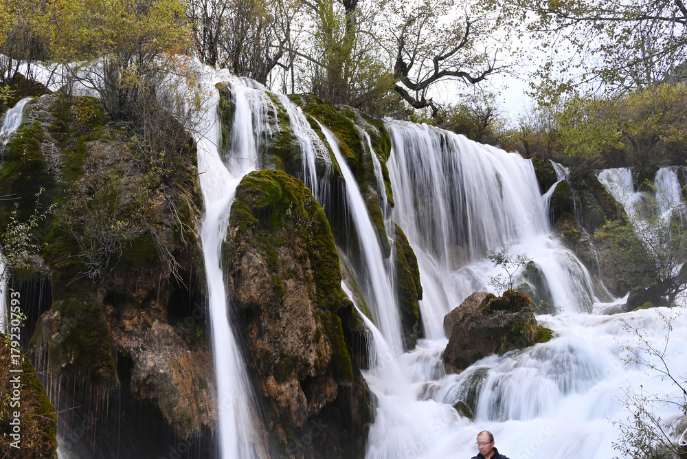 Fototapeta premium view of white waterfall on the rocks in the forest