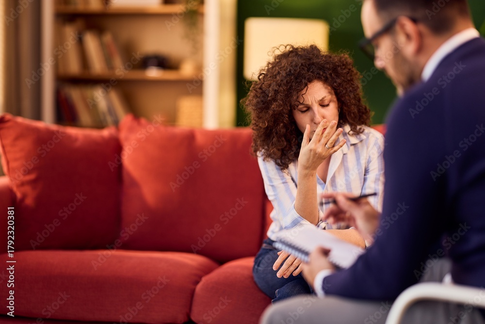 Obraz premium Therapy Session With Distressed Woman On Couch Speaking To Therapist For Support