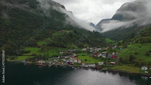 Small fishing village Undredal lies between mountain slopes and a tranquil fjord, Norway