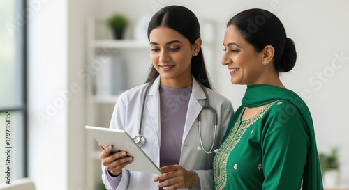Indian Doctor Shares Digital Medical Information with Smiling Patient