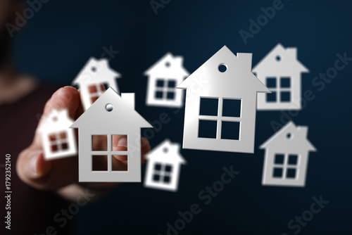 Hand holding multiple house...