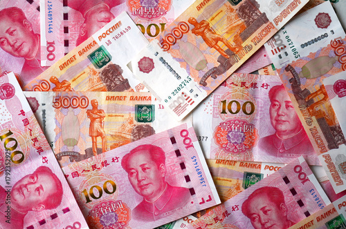 Photography Background with currency of 100 yuan and 5000 ruble, top view, conceptual politi