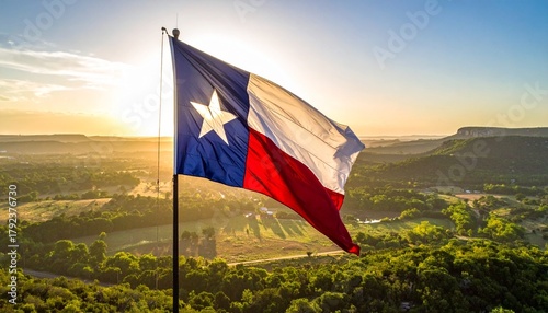 Wallpaper Mural Texas state flag waving over scenic countryside, blue-white-red with lone star, symbol of pride and nature. Torontodigital.ca