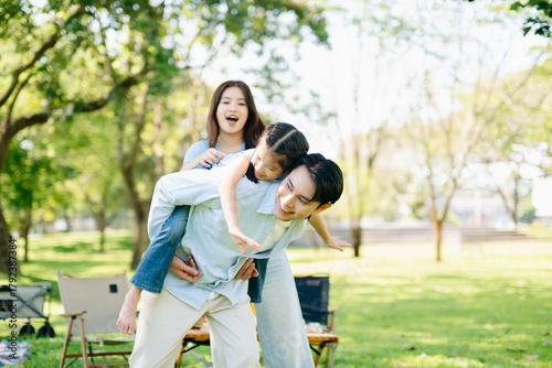Joyful family playing together in a sunny green park. A candid outdoor moment full of love, laughter, and connection