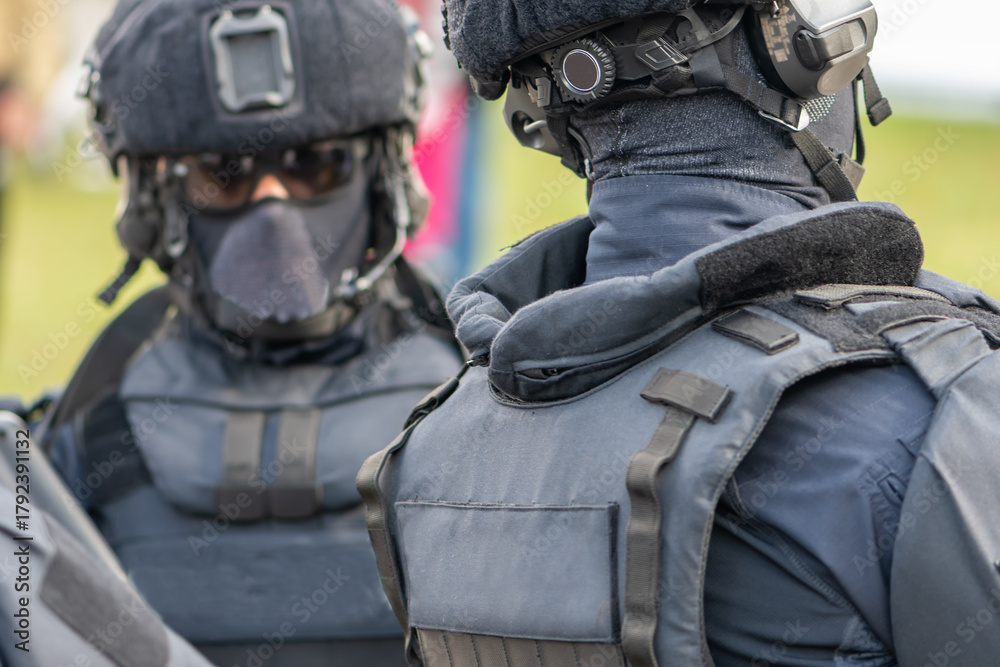 Fototapeta premium police officers are among a crowd of people in equipment with helmets and masks on their faces.
