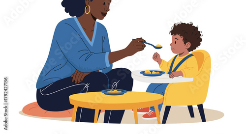 Loving mother feeding her cute toddler healthy baby food with care and affection