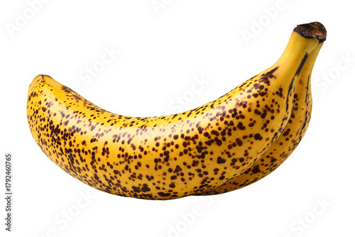 a banana with spots on it sitting on a white surface