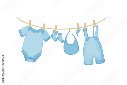 Blue newborn baby apparel including a romper and socks drying on a rope clothesline