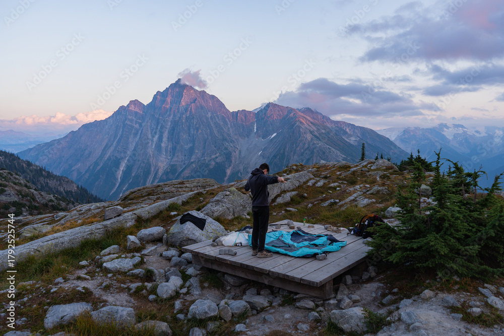 Fototapeta premium Mountain vista with lone camper perched atop scenic wooden platform.