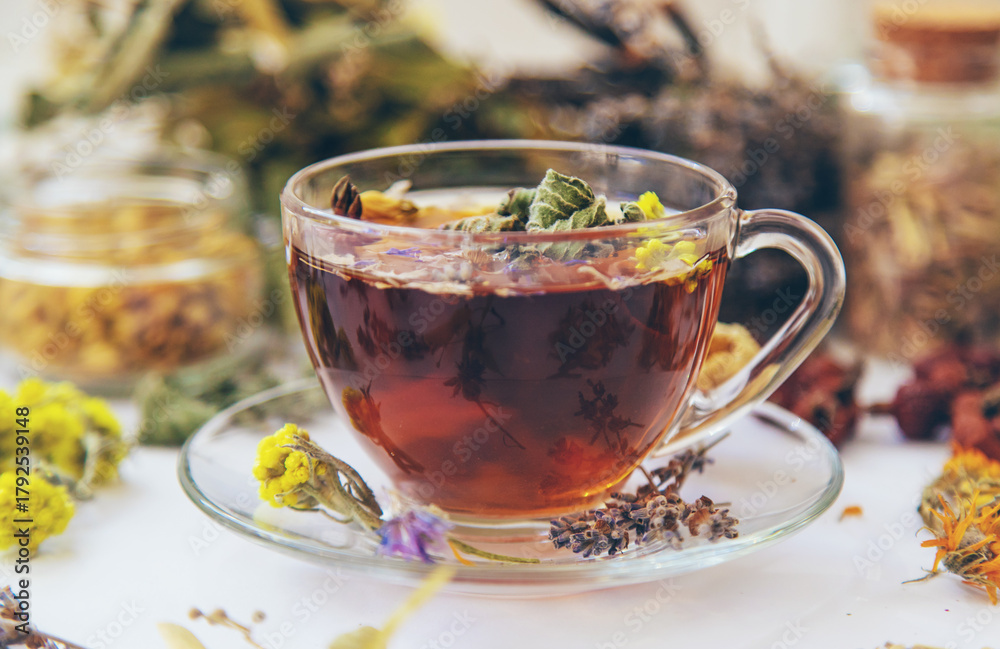 Fototapeta premium Herbal tea with medicinal herbs and flowers. Selective focus.