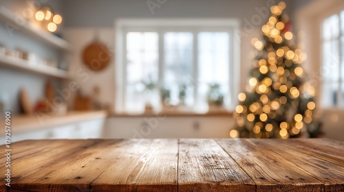 An empty wooden table in a white kitchen with a blurred christmas tree and lights in the background for a christmas promotion or food presentation product display mockup