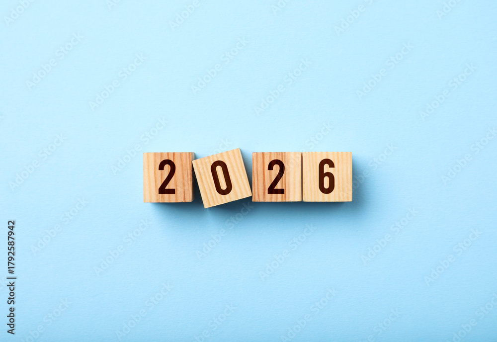 Obraz premium New 2026 year. Cubes with numbers on light blue background, top view