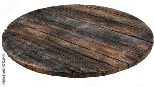 A weathered, circular wooden platform, showing planks and textures against a black backdrop