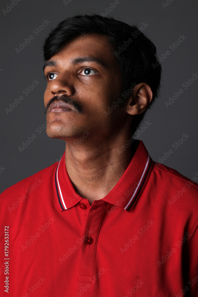 Fototapeta premium Portrait of Indian middleclass young man isolated on studio background. Close shot of confident Indian young man