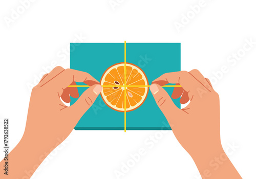 Hands attaching dried orange slice to gift on turquoise background for Christmas  