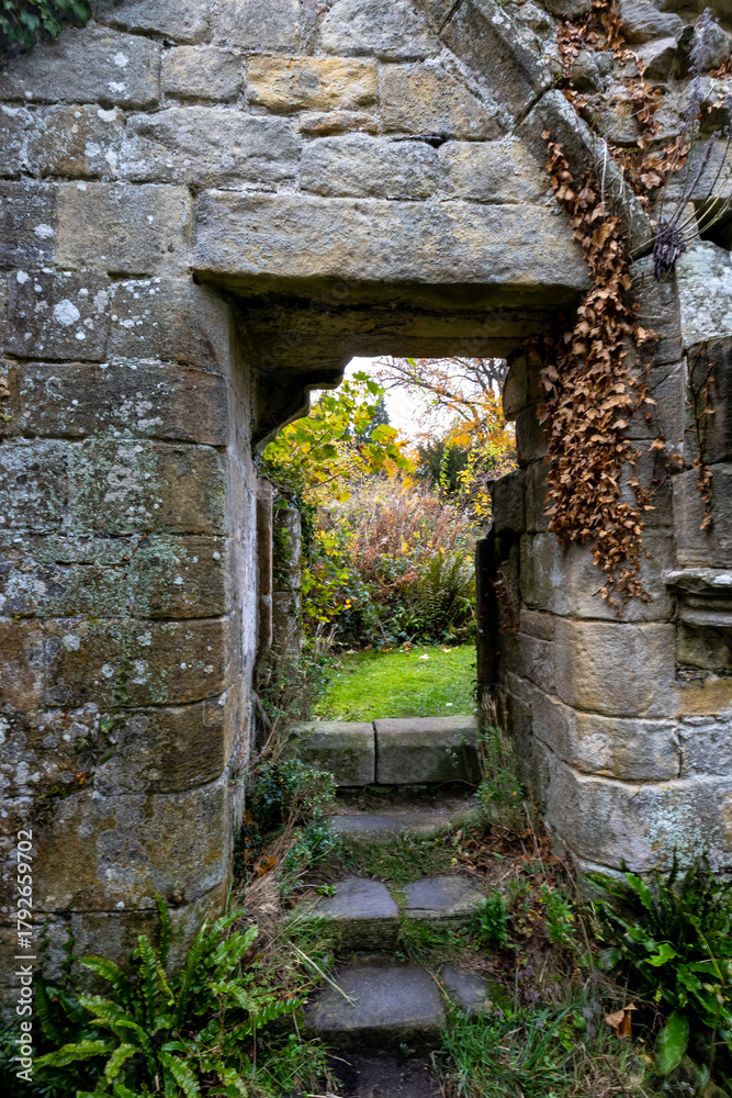 Fototapeta premium Jervaulx Abbey ruins with autumn leaves in morning light