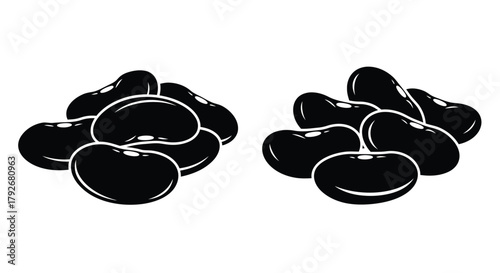 Two piles of black beans arranged in distinct groupings on a white background