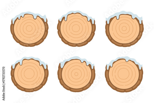 Set of cartoon style tree stump cross sections with snow caps