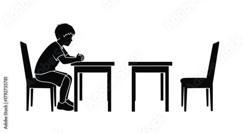 A silhouette of a boy sitting at a desk with an empty chair
