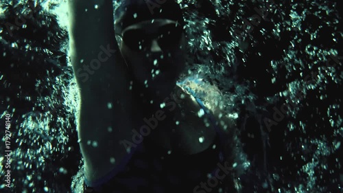 Underwater of Professional Female Swimmer Performing Freestyle Stroke Above Camera