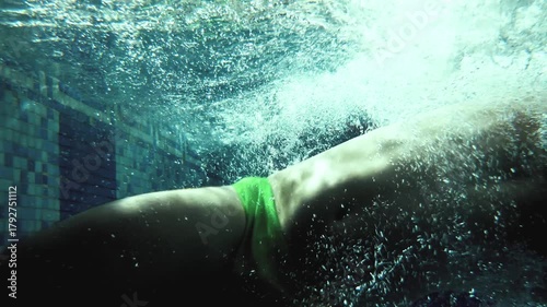 Cinematic Underwater Slow Motion of Professional Male Swimmer Performing Butterfly Turn