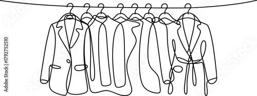 Continuous line drawing of clothes hanging on hangers. Collection of coats and jackets fashion concept