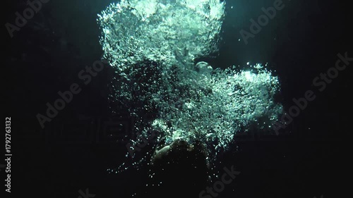 Cinematic Underwater Portrait of Powerful Athlete Releasing Air Bubbles
