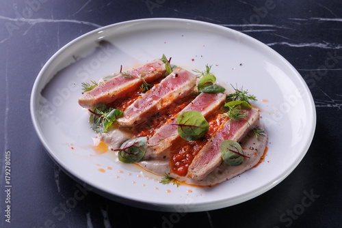 Seared Tuna Steak Slices on Creamy Sauce with Fresh Greens