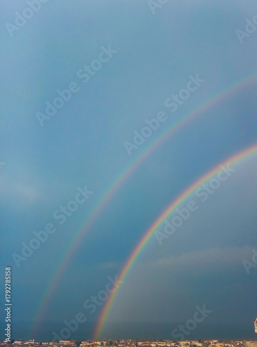 rainbow over the sea, dark blue sky view